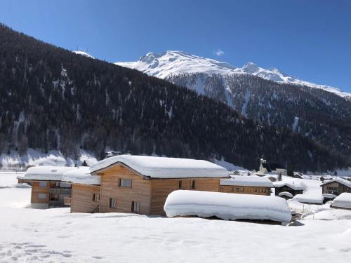 a building covered in snow in front of a mountain at Chalet Breithorn- Perfect for Holiday with Amazing View! in Obergesteln