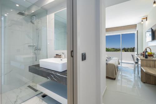 a bathroom with a sink and a shower at Castellum Suites - All Inclusive in Rhodes Town