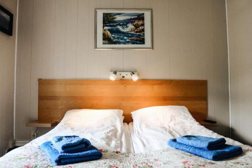 a bed with two towels sitting on top of it at Førde Pensjonat in Førde