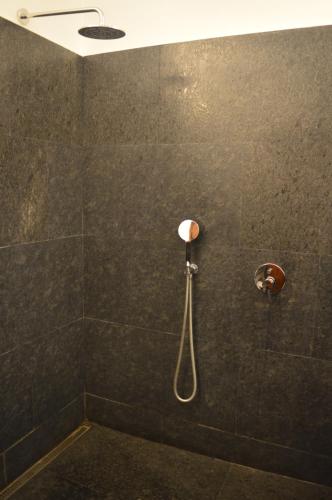 a bathroom with a shower with a shower head at Malabar House in Cochin