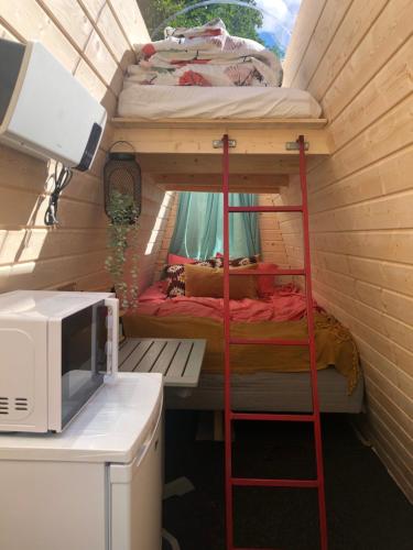 a room with two bunk beds and a microwave at Family Skylight in Laitila