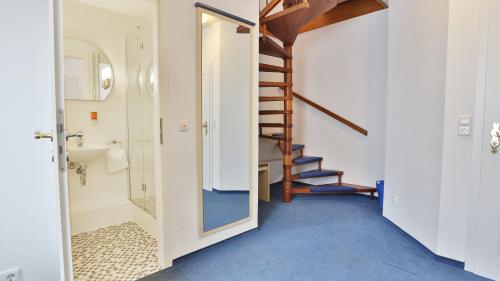 a bathroom with a staircase and a sink and a toilet at Altstadt Hotel in Heidelberg