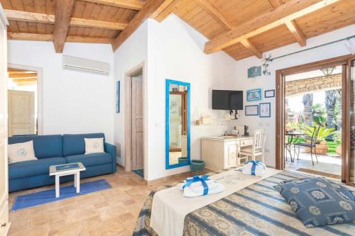 a living room with a blue couch and a table at Villa Flumini in Flumini di Quartu