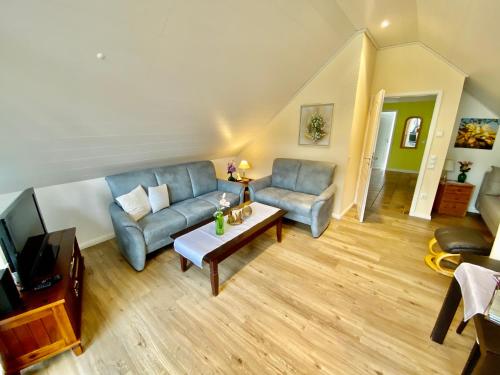 a living room with a couch and a table at Haus Petersen in Undeloh