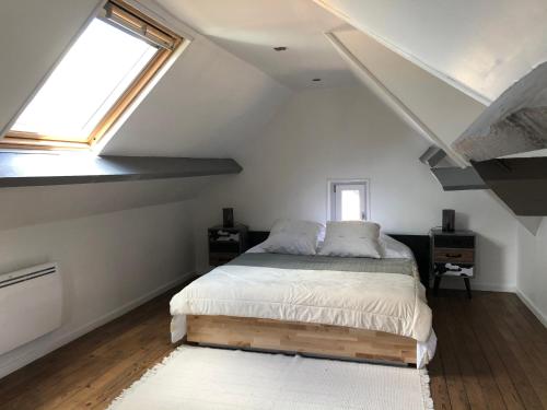 Schlafzimmer mit einem Bett und einem Fenster in der Unterkunft Haras Cour Lozey in Sainte-Marguerite-des-Loges