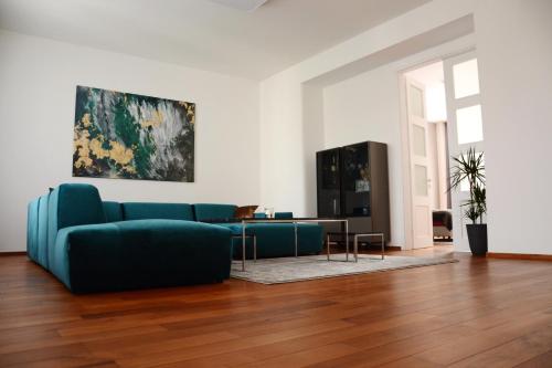 a living room with a blue couch and a table at Premium apartment near Banská Bystrica square with two big bedrooms in Banská Bystrica