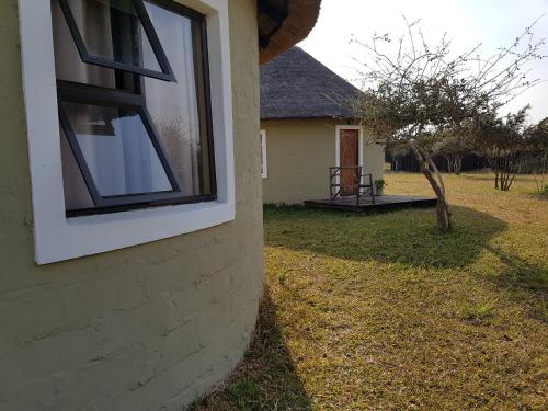 a window on the side of a house at Izulu Eco Lodge in Sodwana Bay