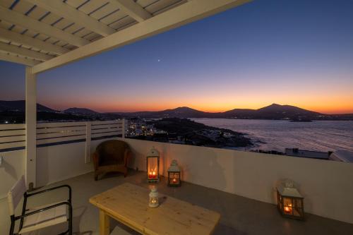 a view from the balcony of a hotel with a view of the ocean at Lorenzo Studios and Suites Paros in Naousa