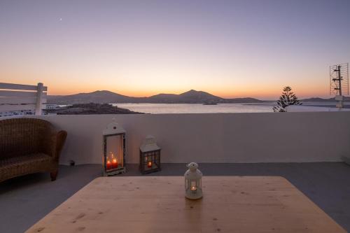 a living room with a table and a view of the ocean at Lorenzo Studios and Suites Paros in Naousa