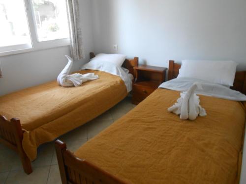 two beds sitting next to each other in a room at Akropolis studios in Laganas