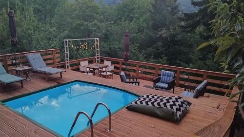 a deck with a swimming pool and chairs and a table at Kedra Village in Kédra