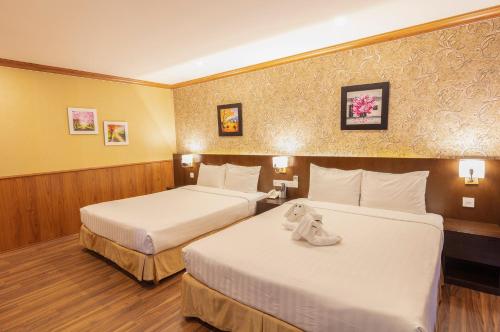 Ένα ή περισσότερα κρεβάτια σε δωμάτιο στο Kings Hotel Dalat