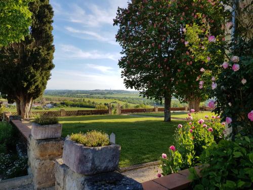 a view of a garden with flowers and trees at Propriété Le Monneton in Sainte-Christie