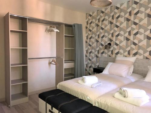 two beds in a room with shelves at Le coin de Fréderic in Colmar