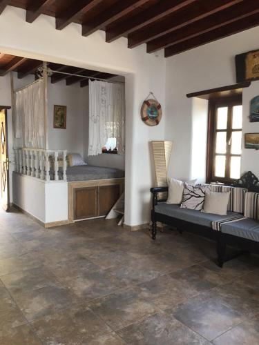 a bedroom with two beds and a couch in a room at Loukakia apartments in Patmos