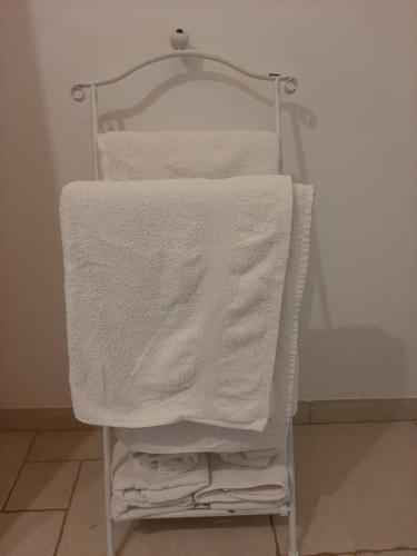 un toallero con toallas blancas. en La perla bianca, en Ostuni
