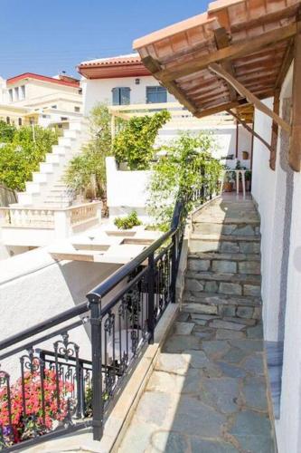a balcony with a black railing and stairs next to a building at Traditional House under Kazarma Fortress in Sitia in Sitia