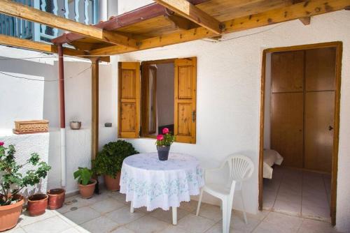 a table with a flower vase on it on a patio at Traditional House under Kazarma Fortress in Sitia in Sitia