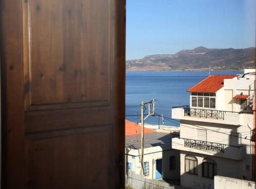 an open door to a view of the ocean at Traditional House under Kazarma Fortress in Sitia in Sitia