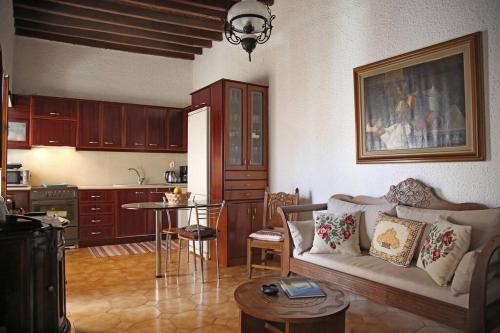 a living room with a couch and a kitchen at Traditional House under Kazarma Fortress in Sitia in Sitia