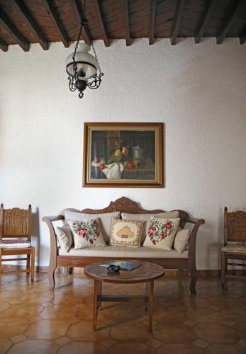 a living room with a couch and a table at Traditional House under Kazarma Fortress in Sitia in Sitia