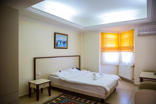 a bedroom with a large bed in a room at Bodrum Marma Otel in Bodrum City