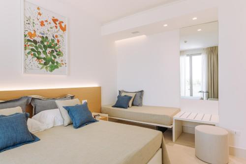a bedroom with two beds and a window at Miramare Blue Stay in Torre Santa Sabina