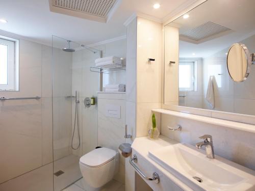 a bathroom with a toilet and a sink and a shower at Apollo Beach in Faliraki