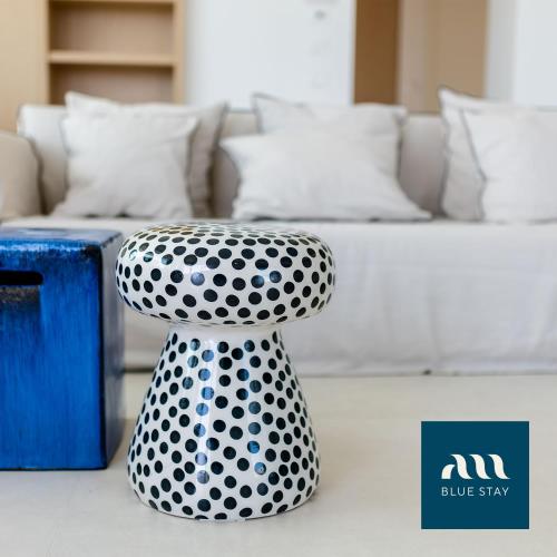 a black and white stool sitting next to a bed at Miramare Blue Stay in Torre Santa Sabina