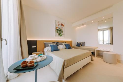 a bedroom with a bed and a table with cupcakes on it at Miramare Blue Stay in Torre Santa Sabina