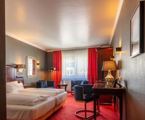 a hotel room with two beds and a living room at Hotel Haverkamp in Bremerhaven