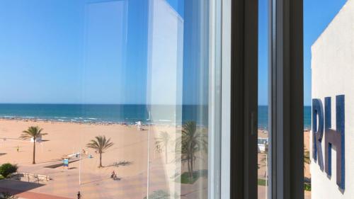 a view of the beach from a hotel window at Hotel RH Riviera - Adults Only in Gandía