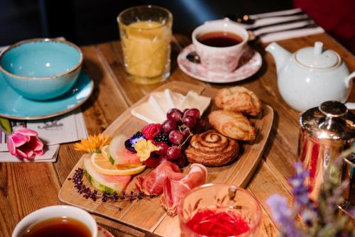 a wooden table topped with a tray of breakfast food at Newton Hall in Chathill