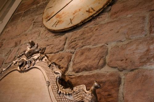a clock on the side of a stone wall at Newton Hall in Chathill