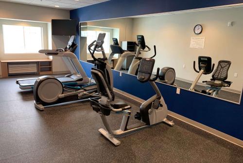 a gym with cardio machines and a mirror at Microtel Inn & Suites by Wyndham Fountain Fort Carson in Fountain