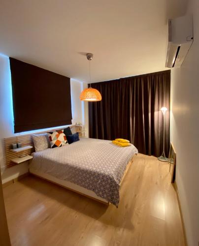 a bedroom with a bed and a large window at Fat Cow Apartment 102 in Livadhia