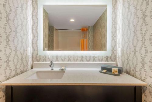 a bathroom with a sink and a mirror at La Quinta by Wyndham Aberdeen-APG in Aberdeen