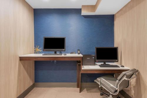 an office with two computer monitors on a desk at La Quinta by Wyndham Aberdeen-APG in Aberdeen