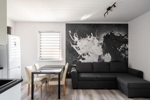 a living room with a couch and a table at RentPlanet - Apartamenty Na Grobli in Wrocław
