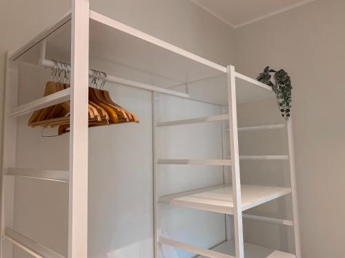 a closet with white shelves and a ladder at Casa Mar - B&B - in Terracina