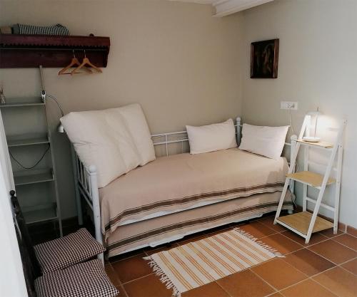 a bed with pillows and a table in a room at Marakasa B&B in Sant Antoni de Calonge