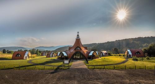 a small church in the middle of a field at Hunnia - Huntanya in Vlăhiţa