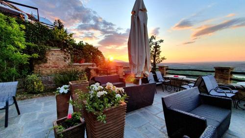 a patio with an umbrella and chairs and a table at Varosi 4 Seasons in Edessa