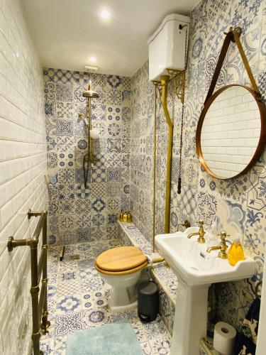 a bathroom with a toilet and a sink at Lovingly Restored Victorian Apartment in Hastings in Hastings