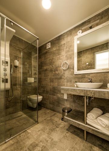 a bathroom with a shower and a sink and a toilet at Casa Bella in Hunedoara