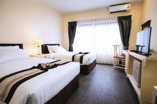 Un ou plusieurs lits dans un hébergement de l'établissement La Seine City Resort, Chiang Mai