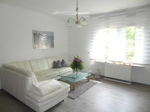 a living room with a white couch and a table at Ruegen_Fewo 37 in Zirkow
