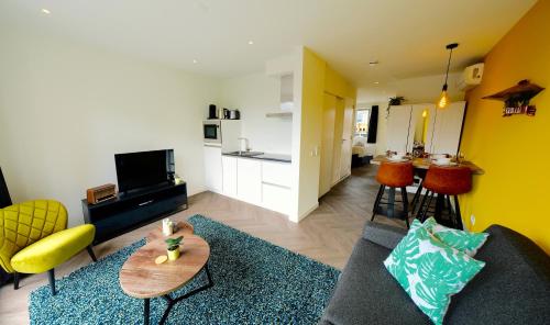 a living room with a couch and a table at Sunny 45m2 Penthouse with Balcony and Terrace - R65C in Eindhoven