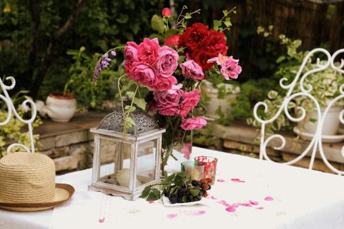 a vase with flowers in it on a table at Art apartman in Kakanj