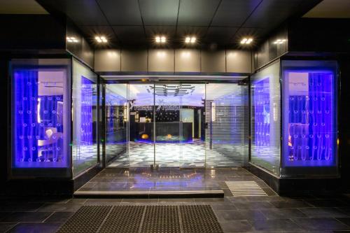 a room with blue lights on the doors of a building at فندق بلاتينيوم الفندقية Platinum Hotel in Al Madinah